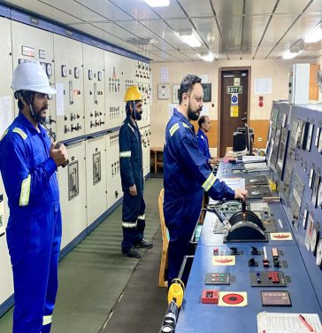 Ship bridge with crew members operating navigation controls, including a captain and officers monitoring instruments and using binoculars.